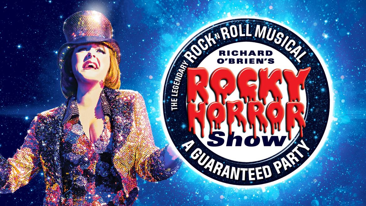 A woman in a sparkly gold jacket and top hat dances in front of the Rocky Horror Show logo