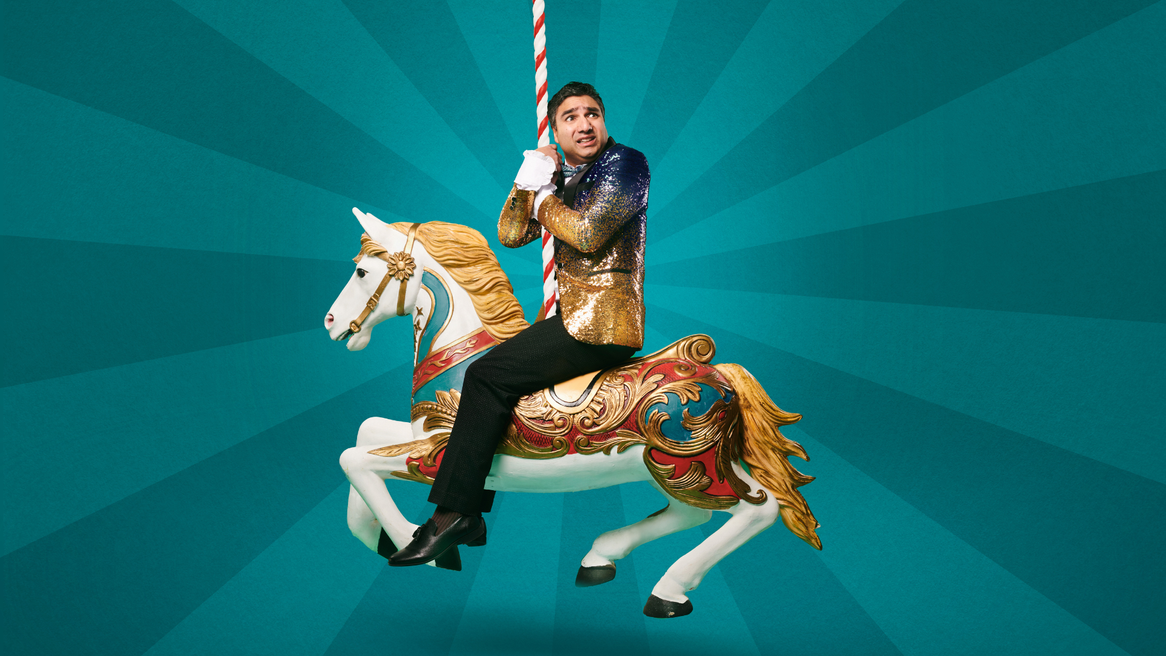 Nick Mohammed on a fairground horse.