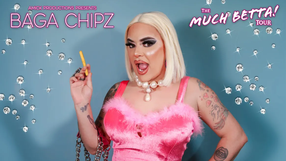 A drag queen in a pink dress and blonde wig poses with a bag full of chips