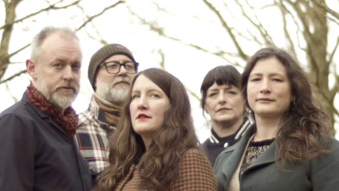 The band The Unthanks in front of leafless trees with a grey sky